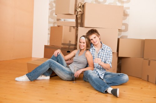 Removal company team loading household items into a van