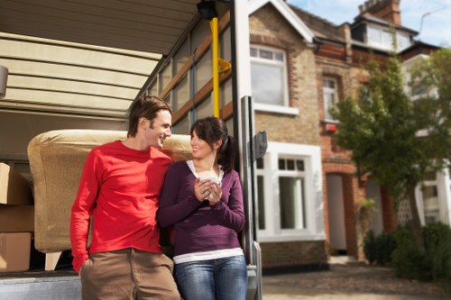 Local movers carrying furniture during a house relocation in Ruislip